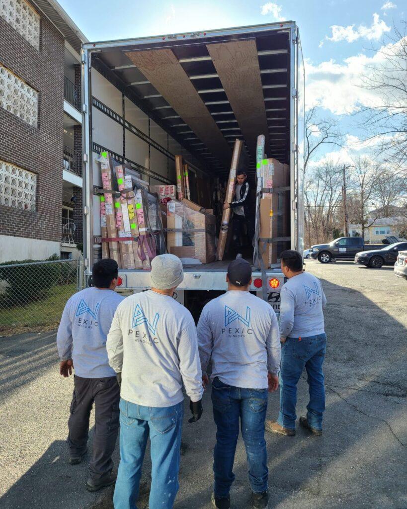 Pexic Windows crew unloading new windows at a job site