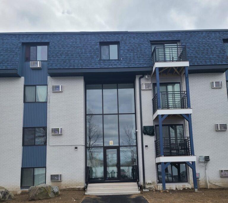 Three-story glass curtain wall at an apartment building entrance by Pexic Windows