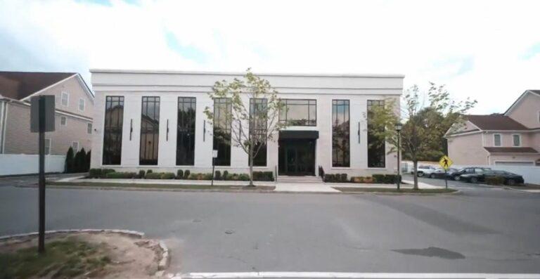 Tall black windows and entry on an institutional building facade by Pexic Windows