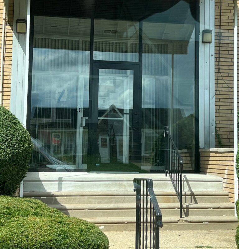 Full-height glass entrance and storefront on an apartment building