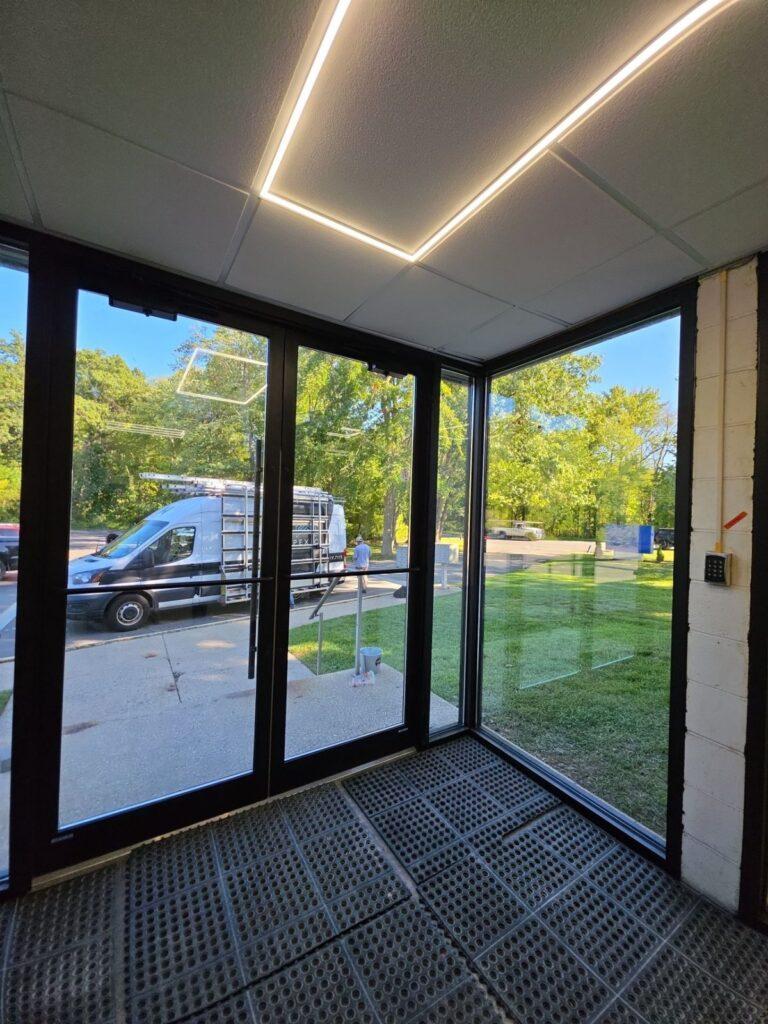 Corner glass vestibule with storefront doors installed by Pexic Windows
