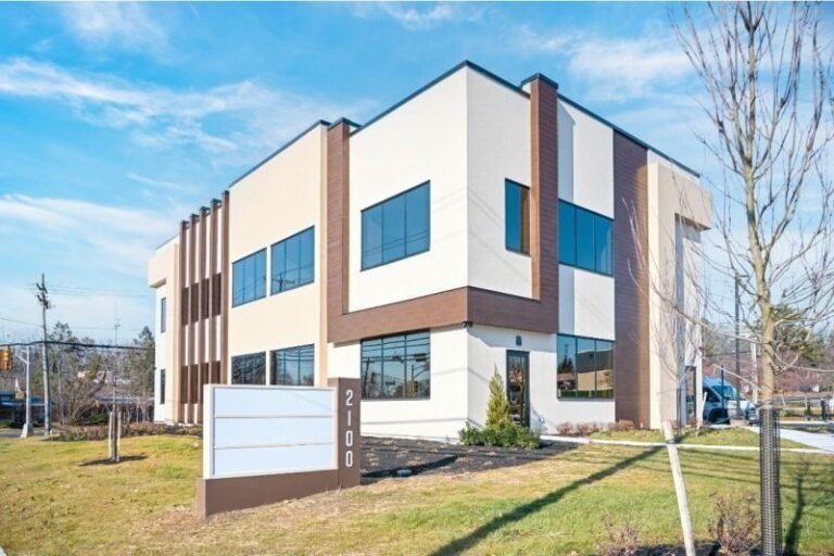 Two-story office building with ribbon windows and storefront entry by Pexic Windows