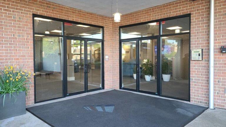 Black aluminum storefront entrances with double doors and sidelights by Pexic Windows