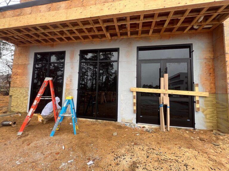 Pexic crew installing storefront doors and windows on a new building