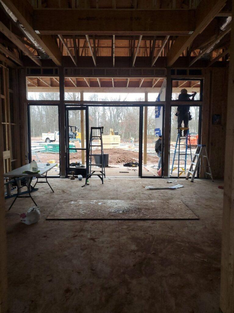Pexic crew installing a storefront system, viewed from inside