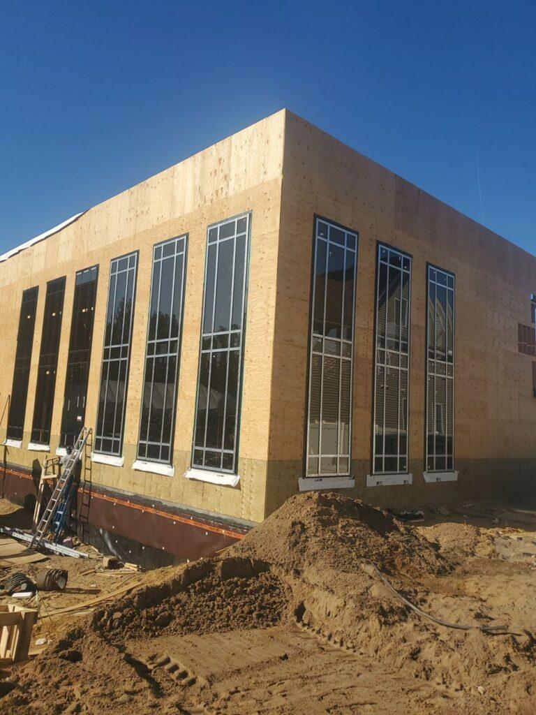 Tall commercial windows on a new building under construction