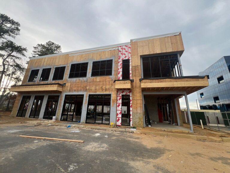 Storefronts and commercial windows on a two-story building under construction