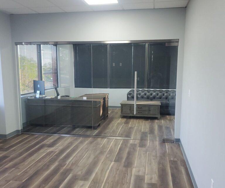 Frameless glass wall and door on a private office by Pexic Windows