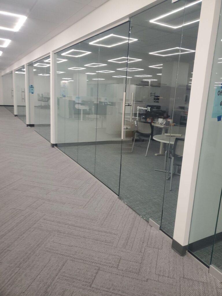 Frameless glass office fronts with door by Pexic Windows