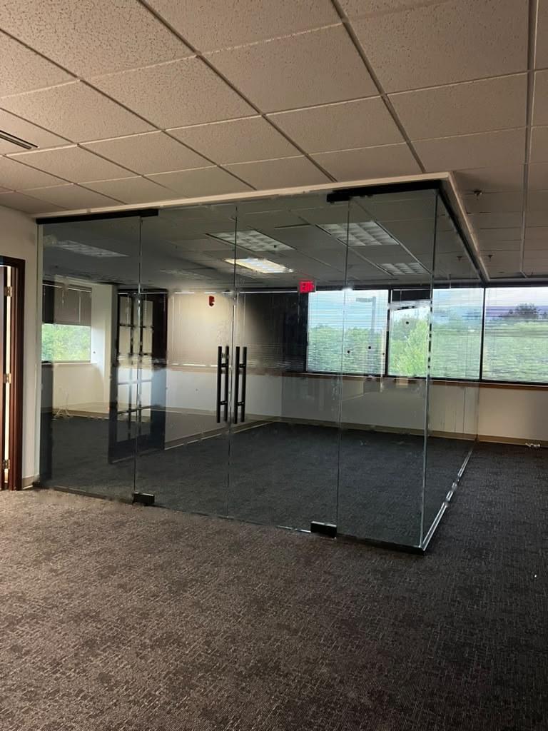 Frameless glass office enclosure with double doors installed by Pexic Windows