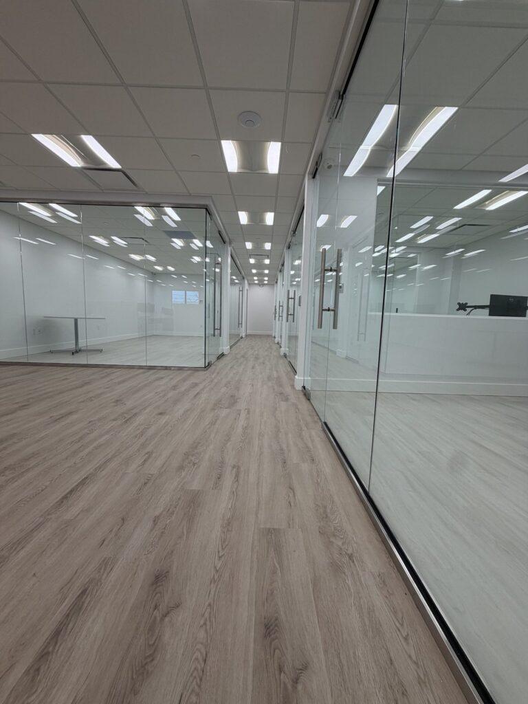 Corridor of frameless glass office fronts by Pexic Windows