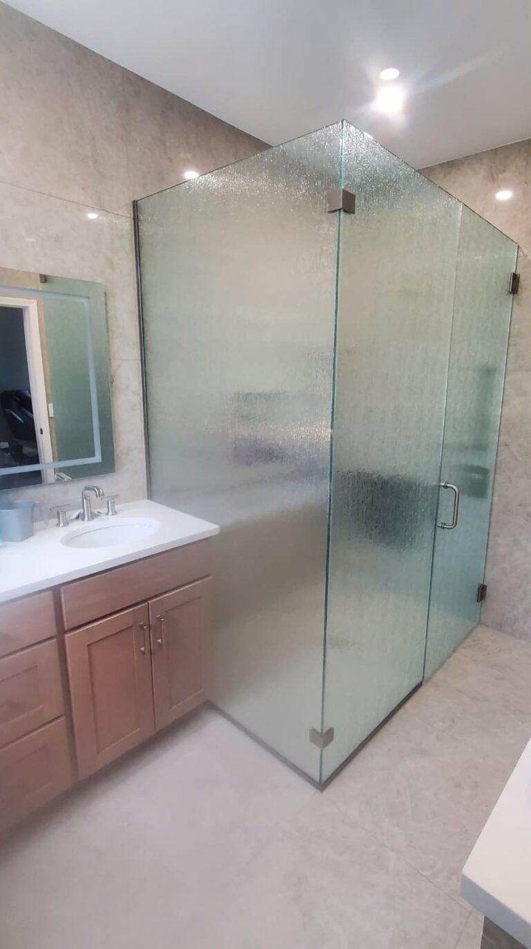 Frameless textured glass corner shower enclosure by Pexic Windows