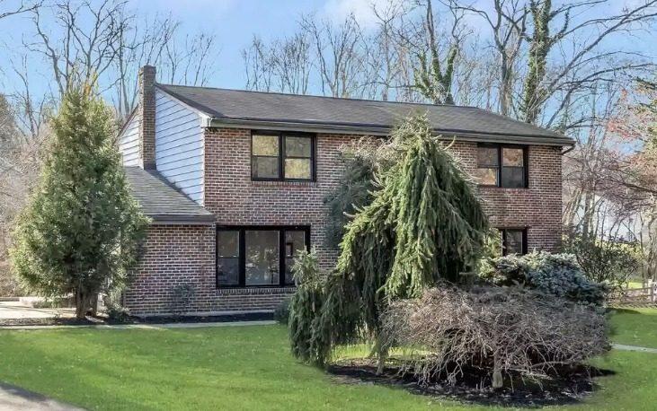Brick home with black replacement windows by Pexic Windows