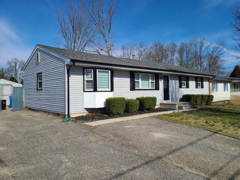 Ranch home with new windows and black trim by Pexic Windows
