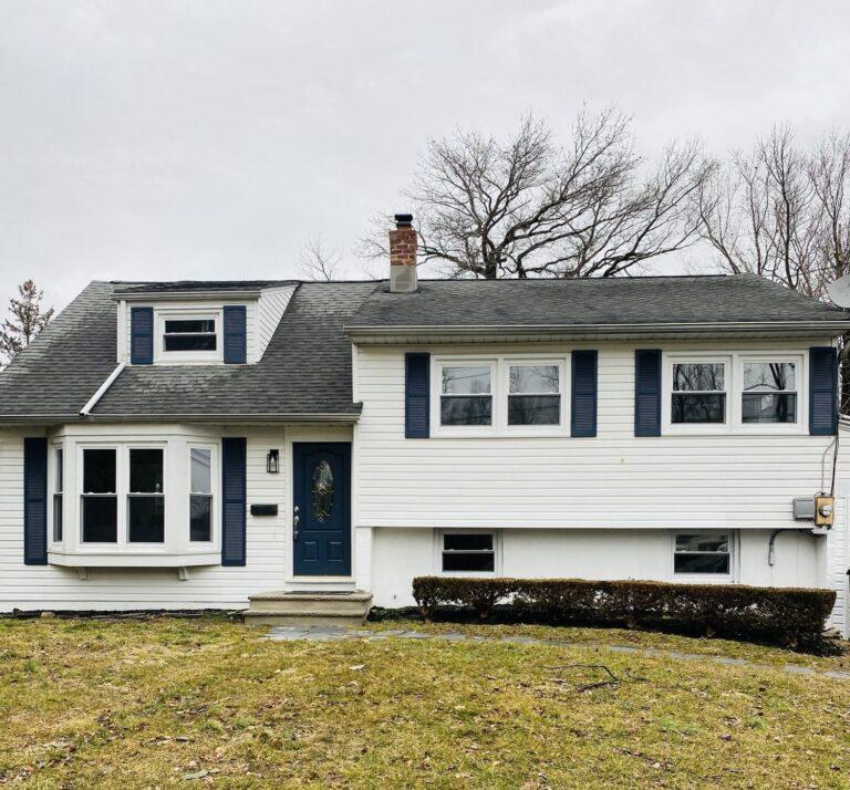 Split-level home with new white windows and bay window by Pexic Windows