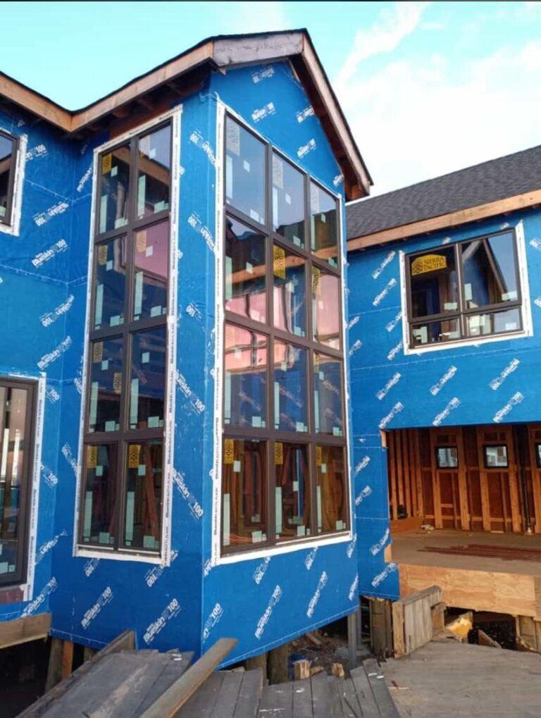 Tall corner window wall on a new home by Pexic Windows