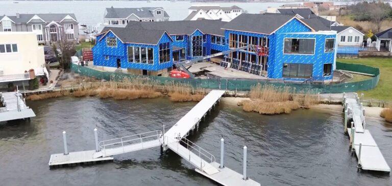 Aerial view of a waterfront custom home under construction by Pexic Windows